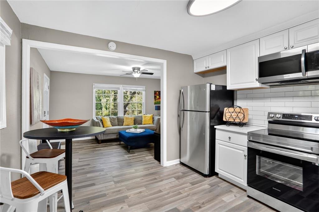 2019 Grant Road Southwest Atlanta, GA 30331 - Photo 2 of 17 a kitchen with stainless steel appliances a stove a refrigerator and a fireplace