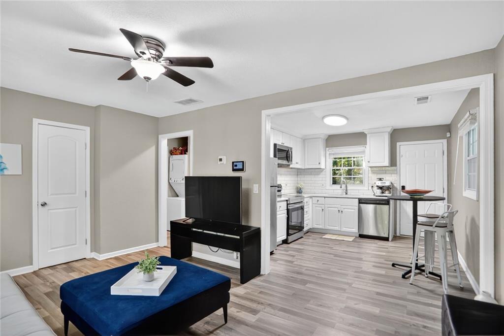 2019 Grant Road Southwest Atlanta, GA 30331 - Photo 4 of 17 a living room with kitchen island furniture and a flat screen tv