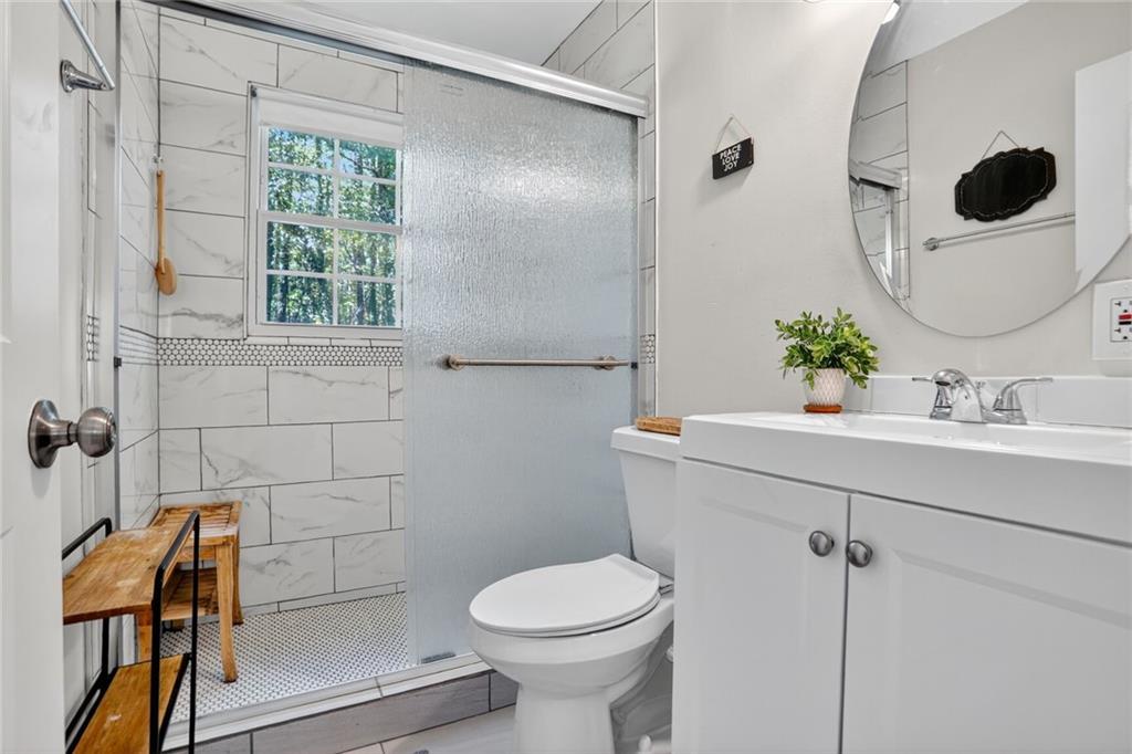 2019 Grant Road Southwest Atlanta, GA 30331 - Photo 7 of 17 a bathroom with a sink mirror toilet and next to a window