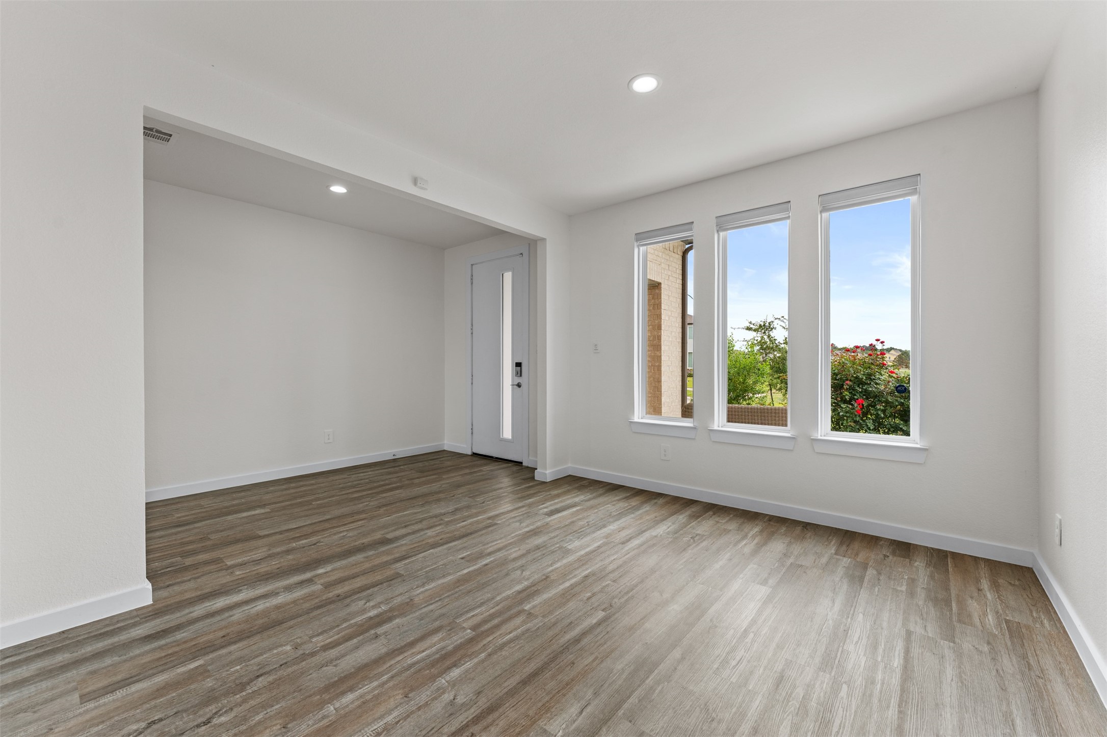 22503 Modica Rift Lane Katy, TX 77449 - Photo 5 of 47 a view of an empty room with wooden floor and a window