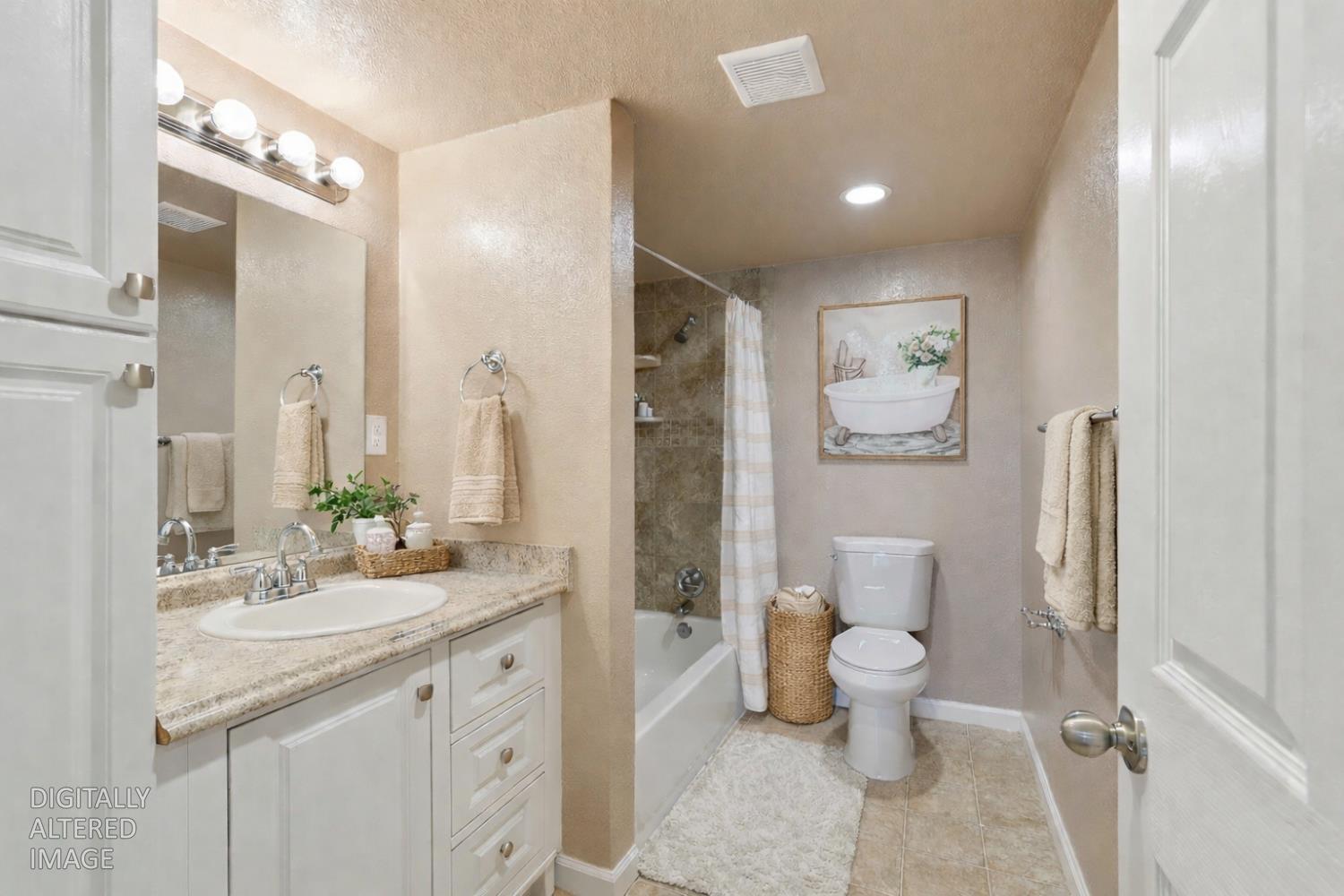 20042 North Ray Road Lodi, CA 95242 - Photo 30 of 63 a bathroom with a double vanity sink toilet and shower