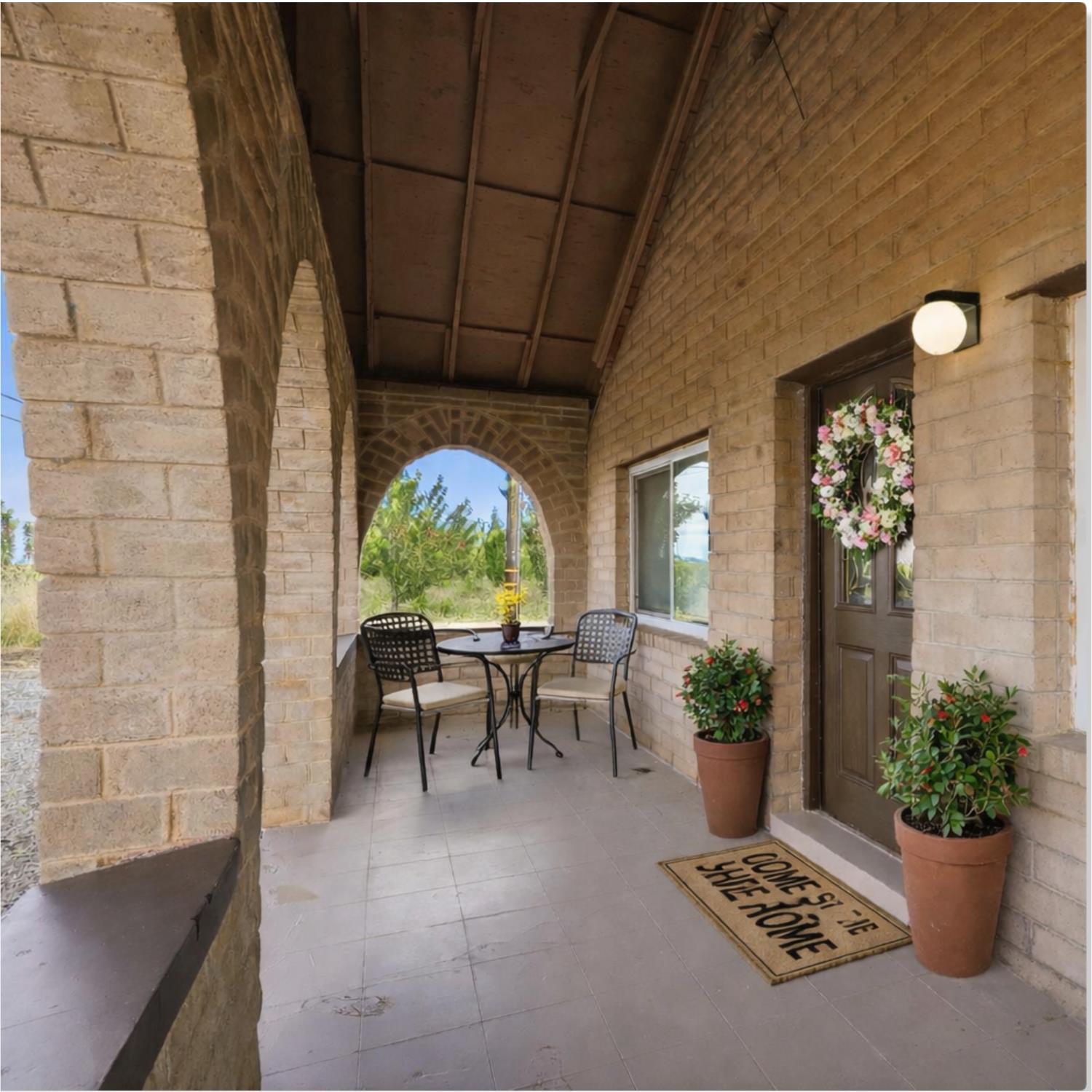 20042 North Ray Road Lodi, CA 95242 - Photo 7 of 63 a view of a porch with chairs and potted plants