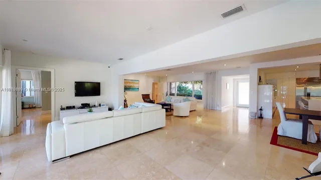 a very nice looking living room with kitchen island furniture and a chandelier
