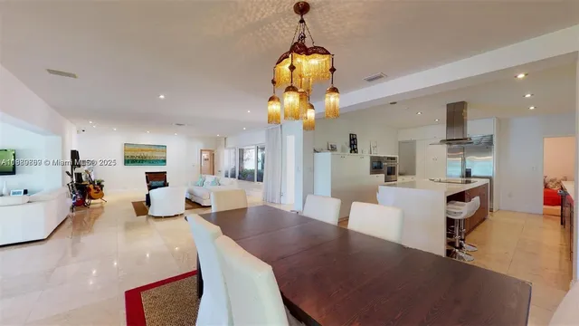 a large kitchen with sink a counter top space and stainless steel appliances