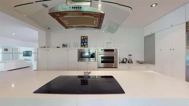 a kitchen with stainless steel appliances a sink stove and cabinets