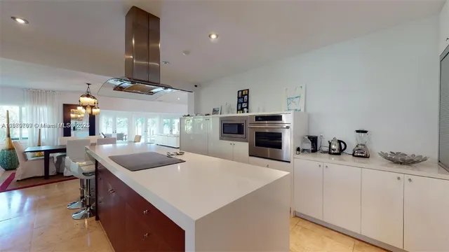 a dining room with furniture and a floor to ceiling window