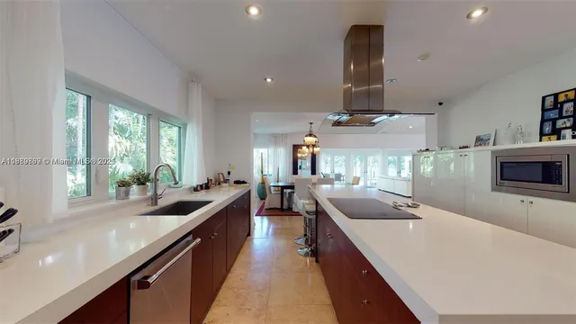 a view of a patio with table and chairs under an umbrella