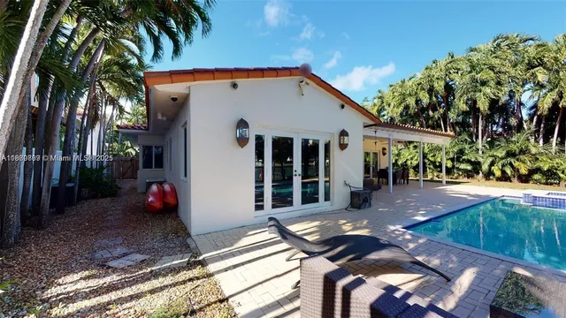 a living room with furniture and large windows