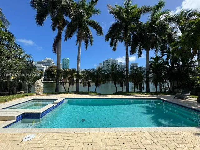 a bedroom with bed and a large window