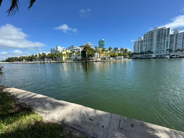 a view of a lake with building and outdoor space