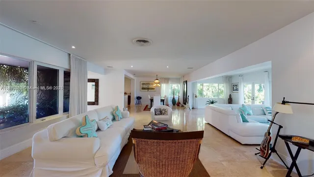 a living room with furniture a dining table and a fireplace