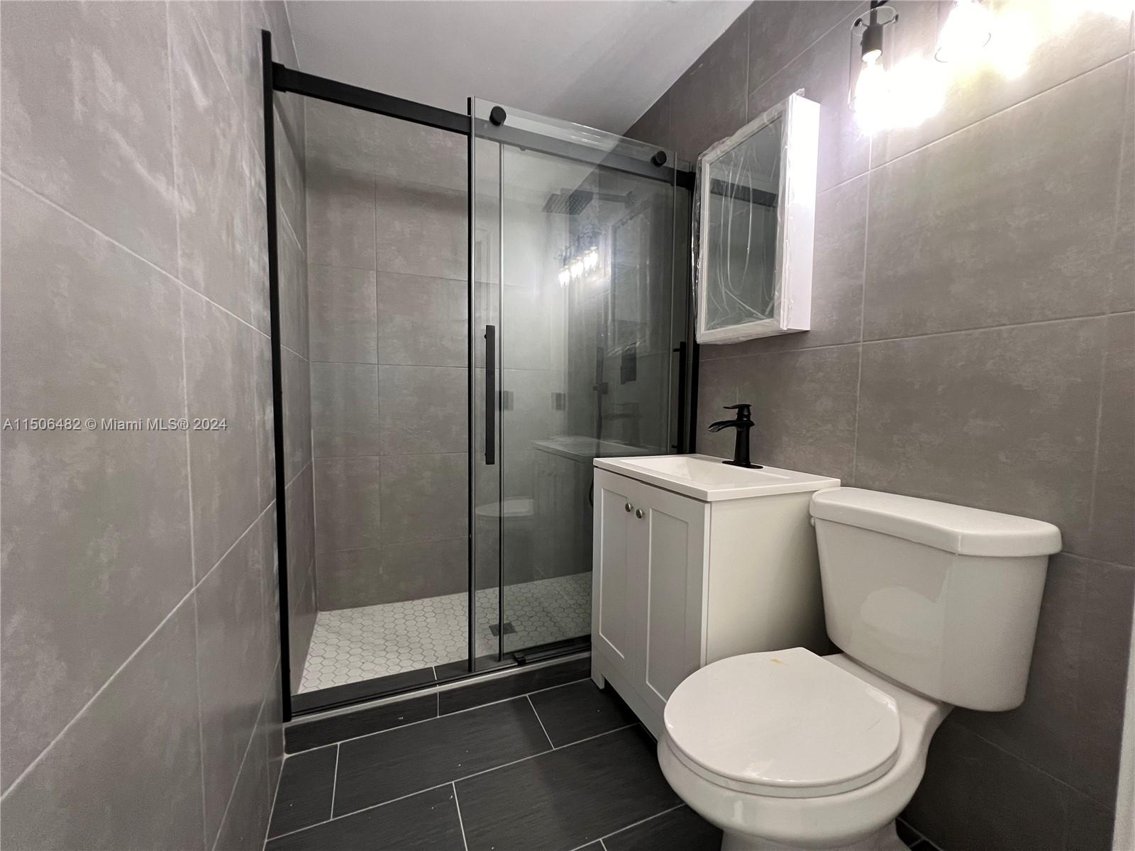 6034 Triphammer Road Lake Worth, FL 33463 - Photo 5 of 10 a white toilet sitting next to a bathroom sink