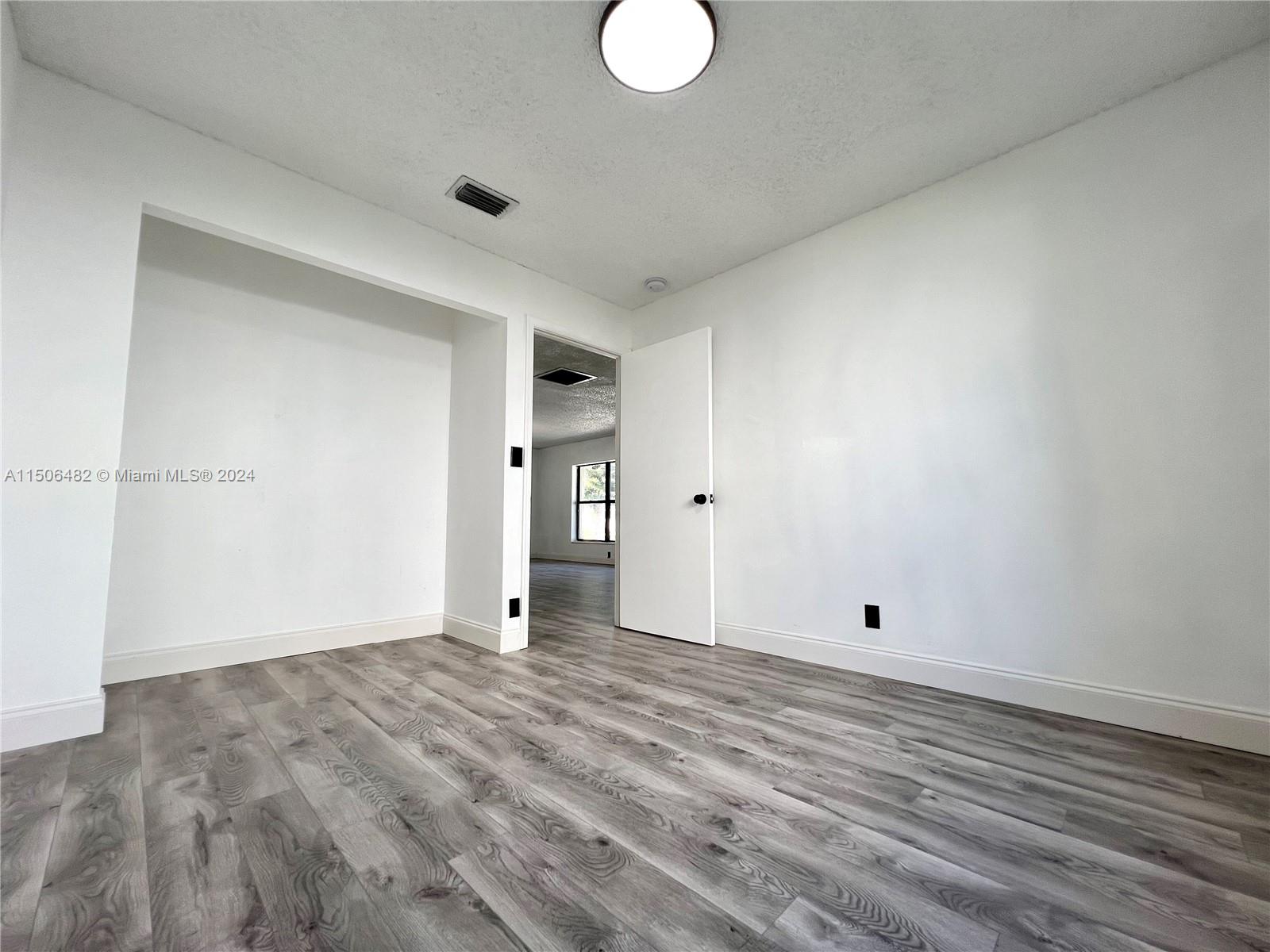 6034 Triphammer Road Lake Worth, FL 33463 - Photo 6 of 10 a view of an empty room