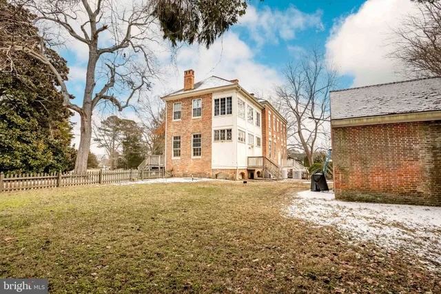 a living room with a fireplace and a large window