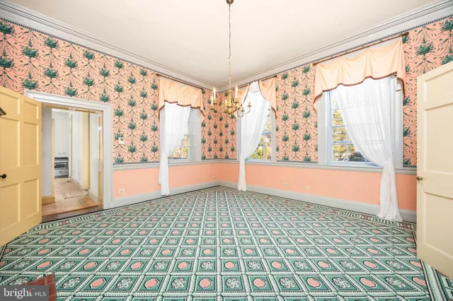 a kitchen with stainless steel appliances a stove a refrigerator a oven a sink with a dining table and chairs