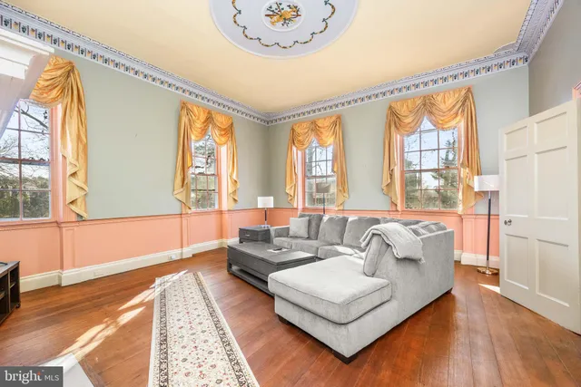 a view of a kitchen with a table and a refrigerator