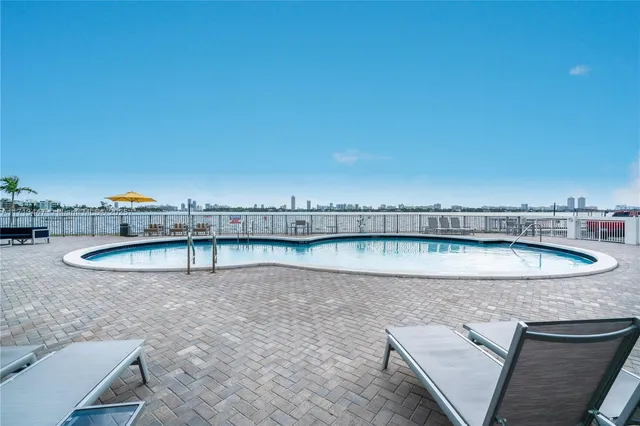 a view of a swimming pool with outdoor seating