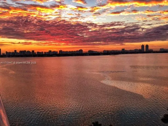 a living room with furniture a rug and a flat screen tv
