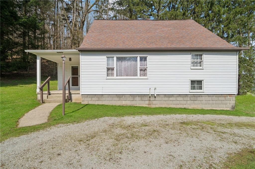 161 Millertown Road Normalville, PA 15469 - Photo 1 of 30 a view of a house with a backyard and a large tree