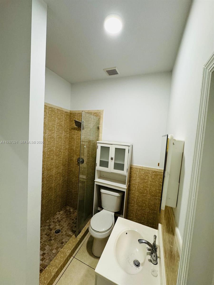 1330 Northwest 5th Street, Unit 1 Miami, FL 33125 - Photo 6 of 15 a bathroom with a sink and a mirror
