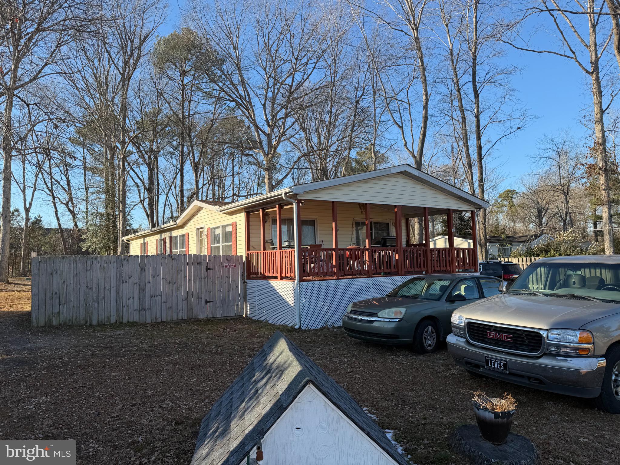 Charming home nestled among tall trees.