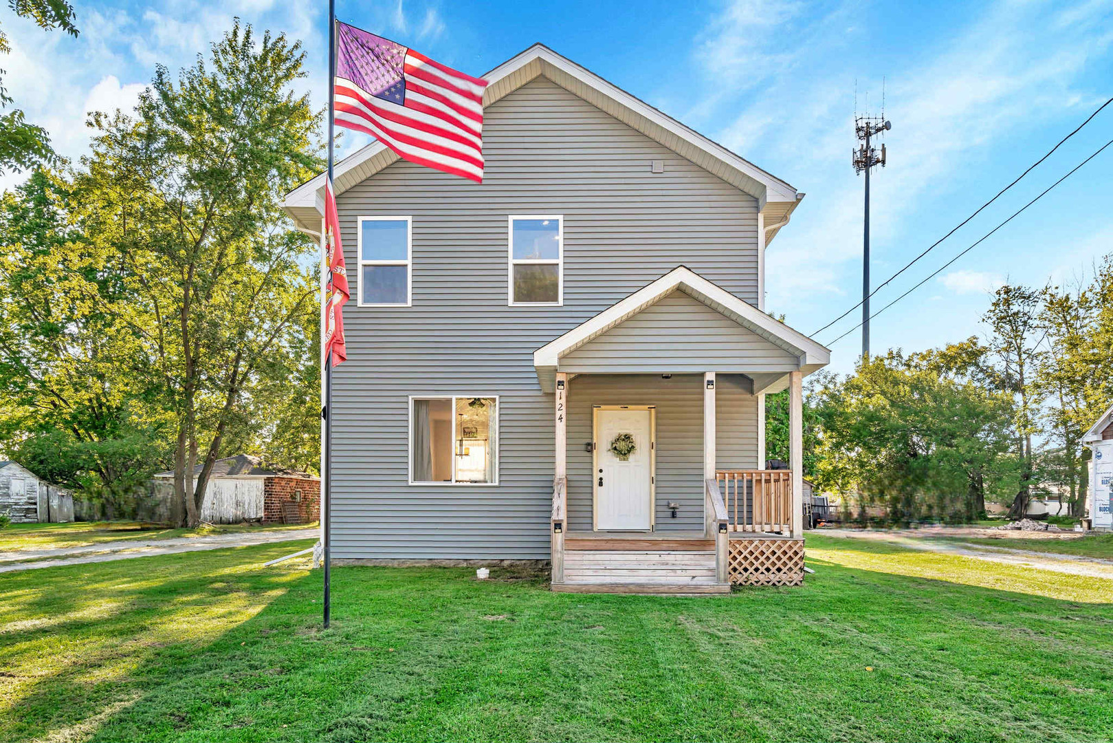 a view of a house with a yard and sitting area