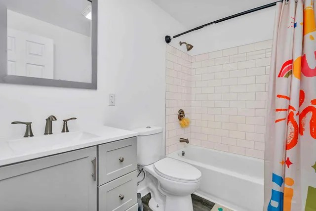 a bathroom with a sink toilet and shower