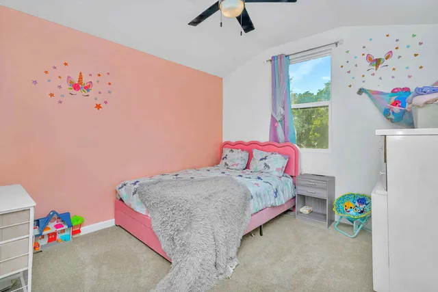 a bedroom with a bed and a dresser