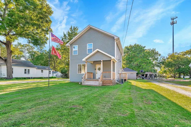 a view of a house with a yard and sitting area