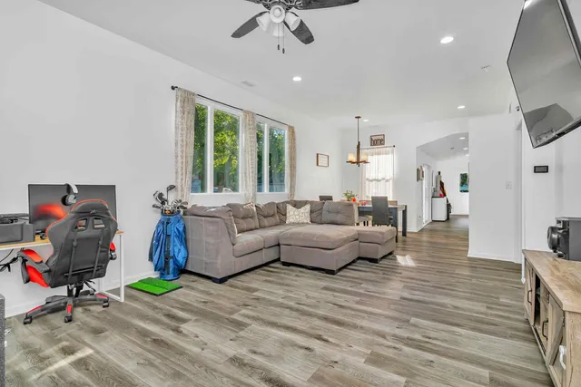 a living room with furniture and a wooden floor