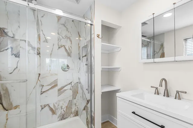a bathroom with a sink a bathtub and a window