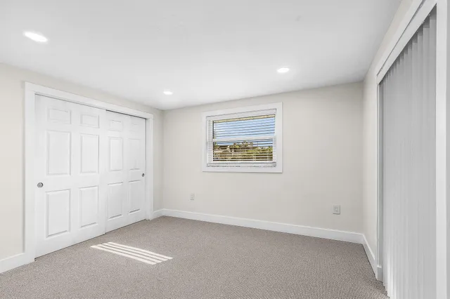a view of a livingroom with wooden floor and a window