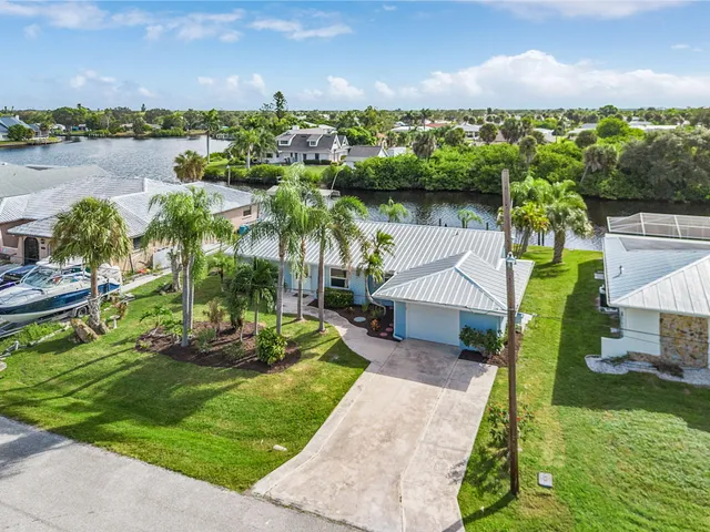 a view of a house with a yard and lake view