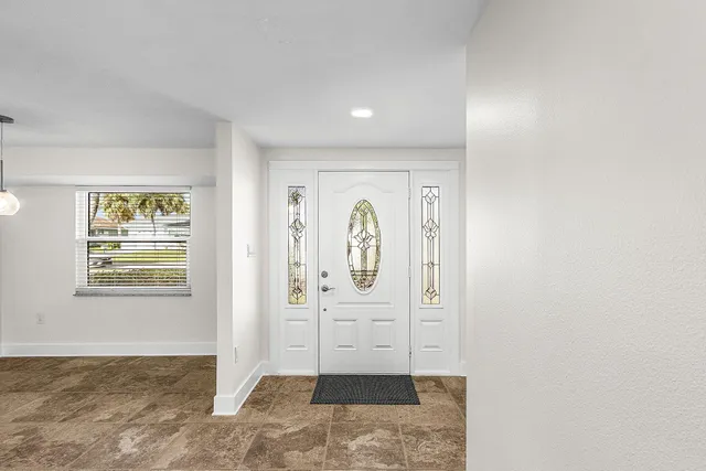 an aerial view of residential houses with outdoor space and swimming pool