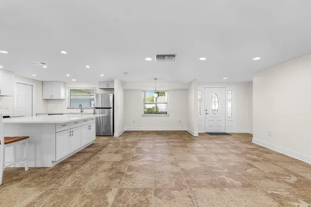 a view of a kitchen with a sink and microwave