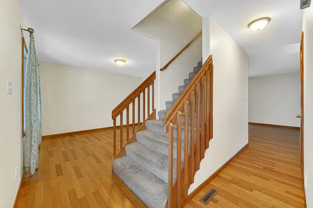 a view of entryway and hall with wooden floor