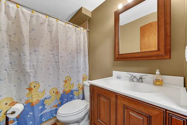 a bathroom with a sink toilet and shower