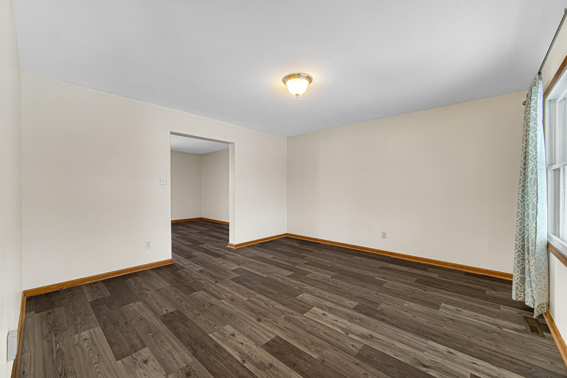 515 Tamarack Trail Hebron, IN 46341 - Photo 3 of 38 a view of an empty room with wooden floor and a window