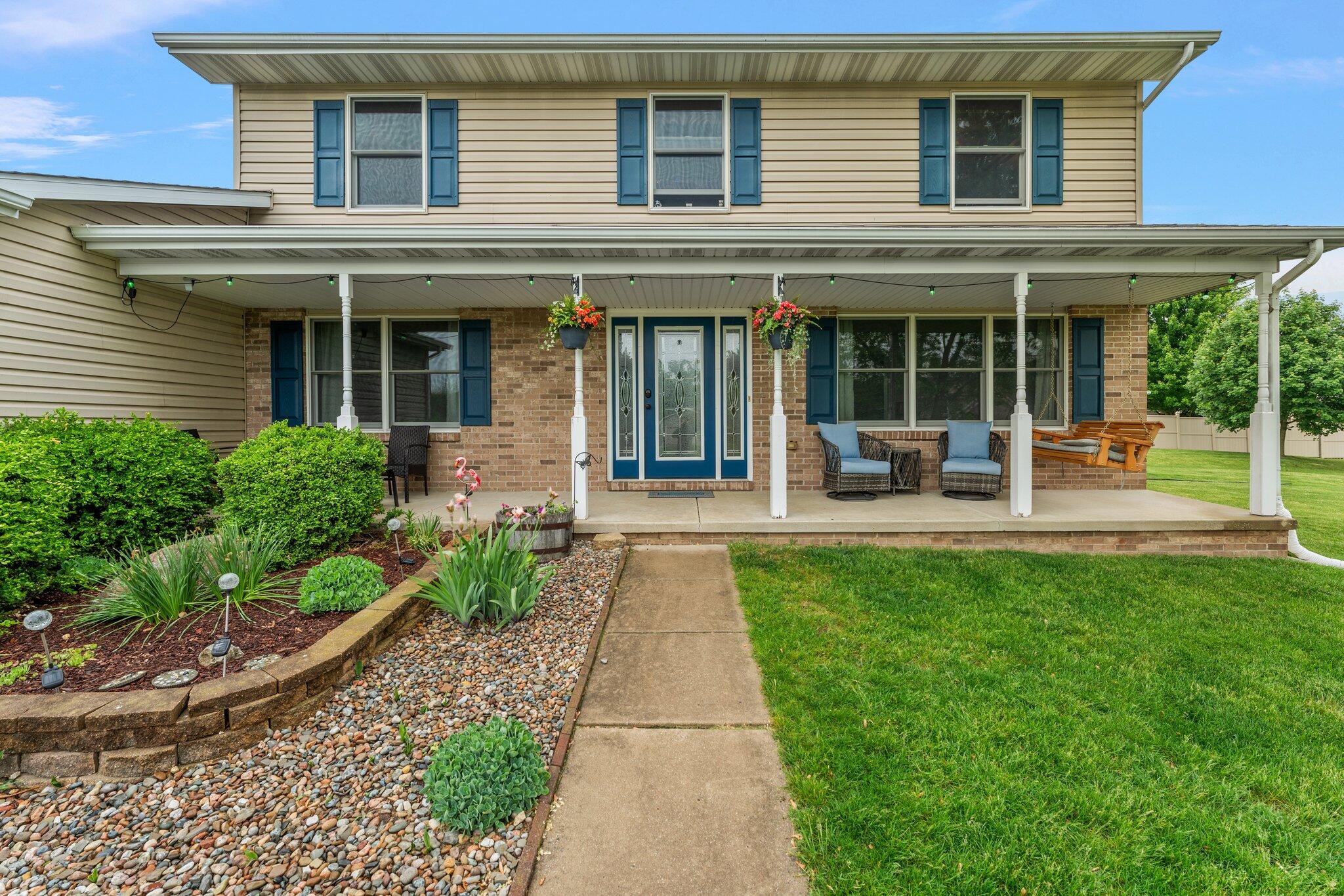 515 Tamarack Trail Hebron, IN 46341 - Photo 31 of 38 a front view of a house with garden and porch