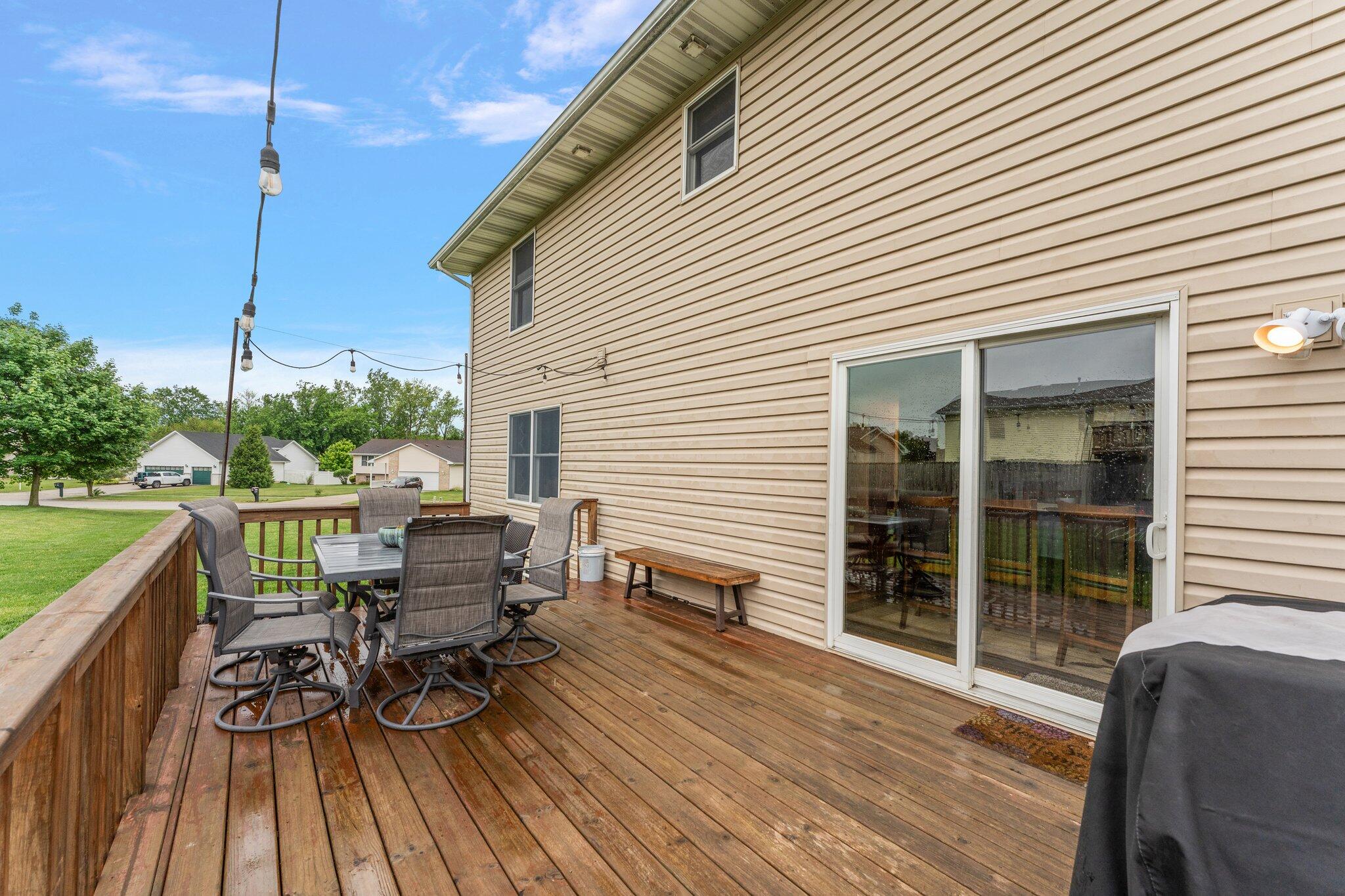 515 Tamarack Trail Hebron, IN 46341 - Photo 35 of 38 a view of a roof deck with table and chairs floor to ceiling window with wooden floor