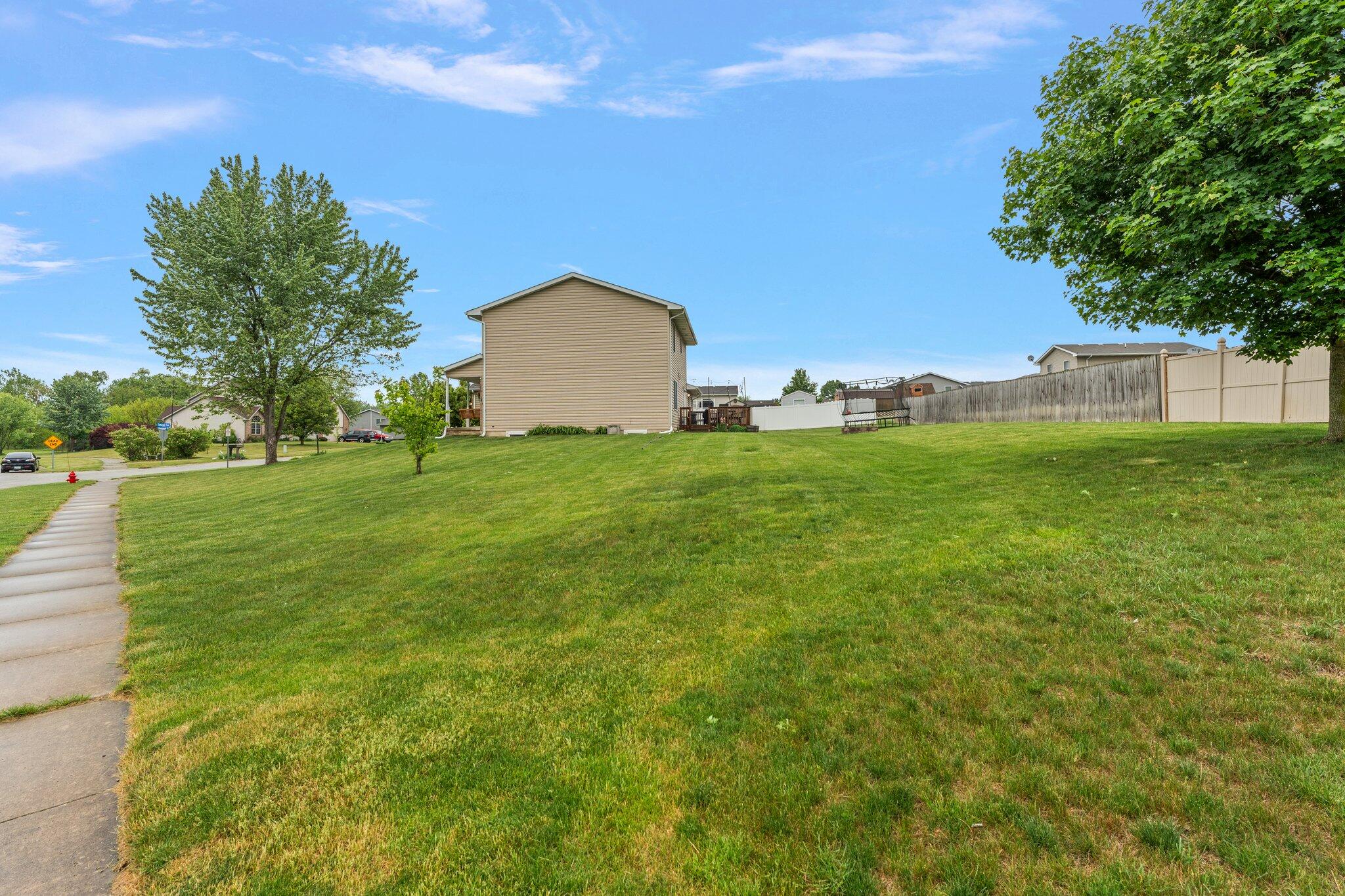 515 Tamarack Trail Hebron, IN 46341 - Photo 37 of 38 a backyard of a house with lots of green space and plants