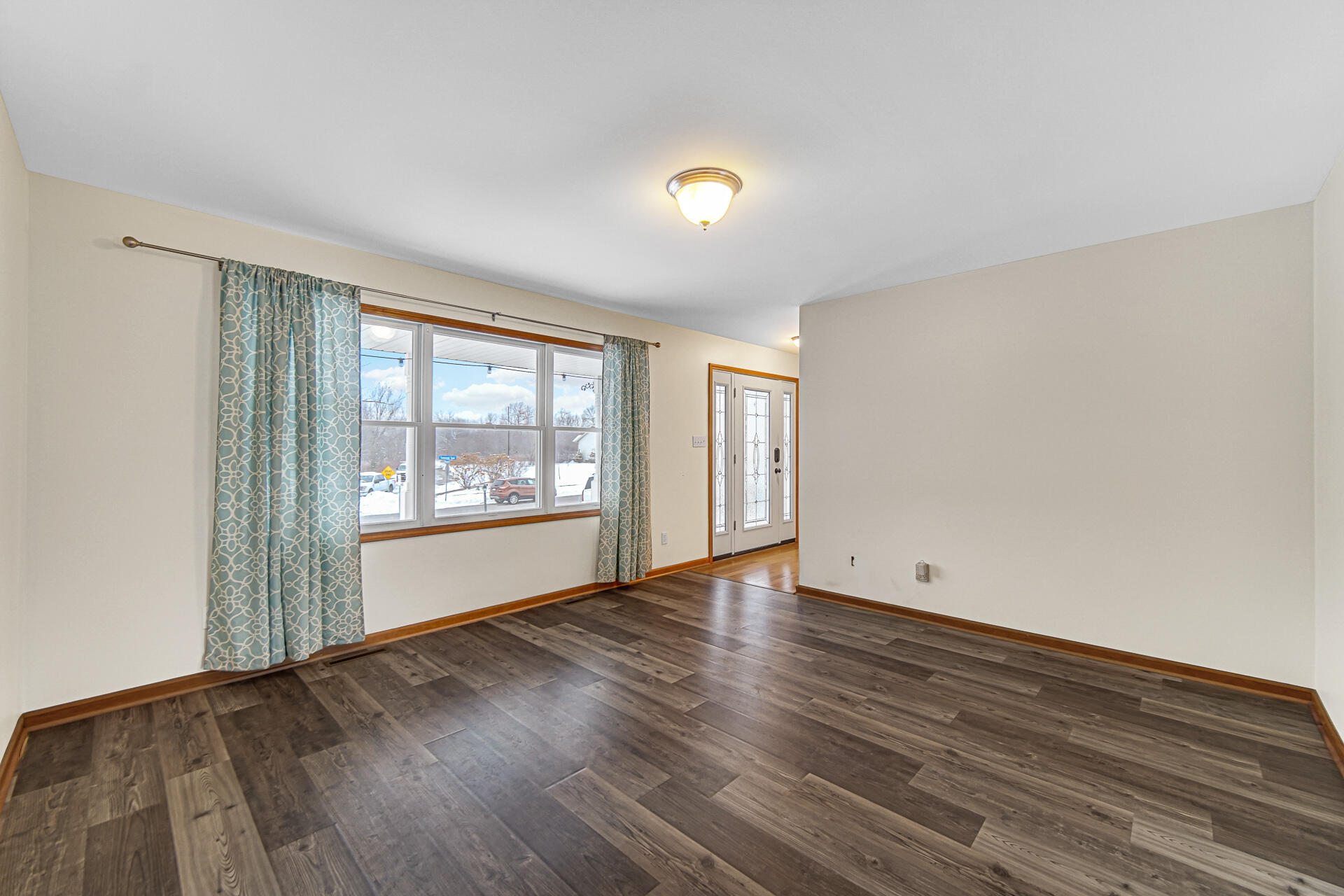 515 Tamarack Trail Hebron, IN 46341 - Photo 4 of 38 a view of an empty room with wooden floor and a window