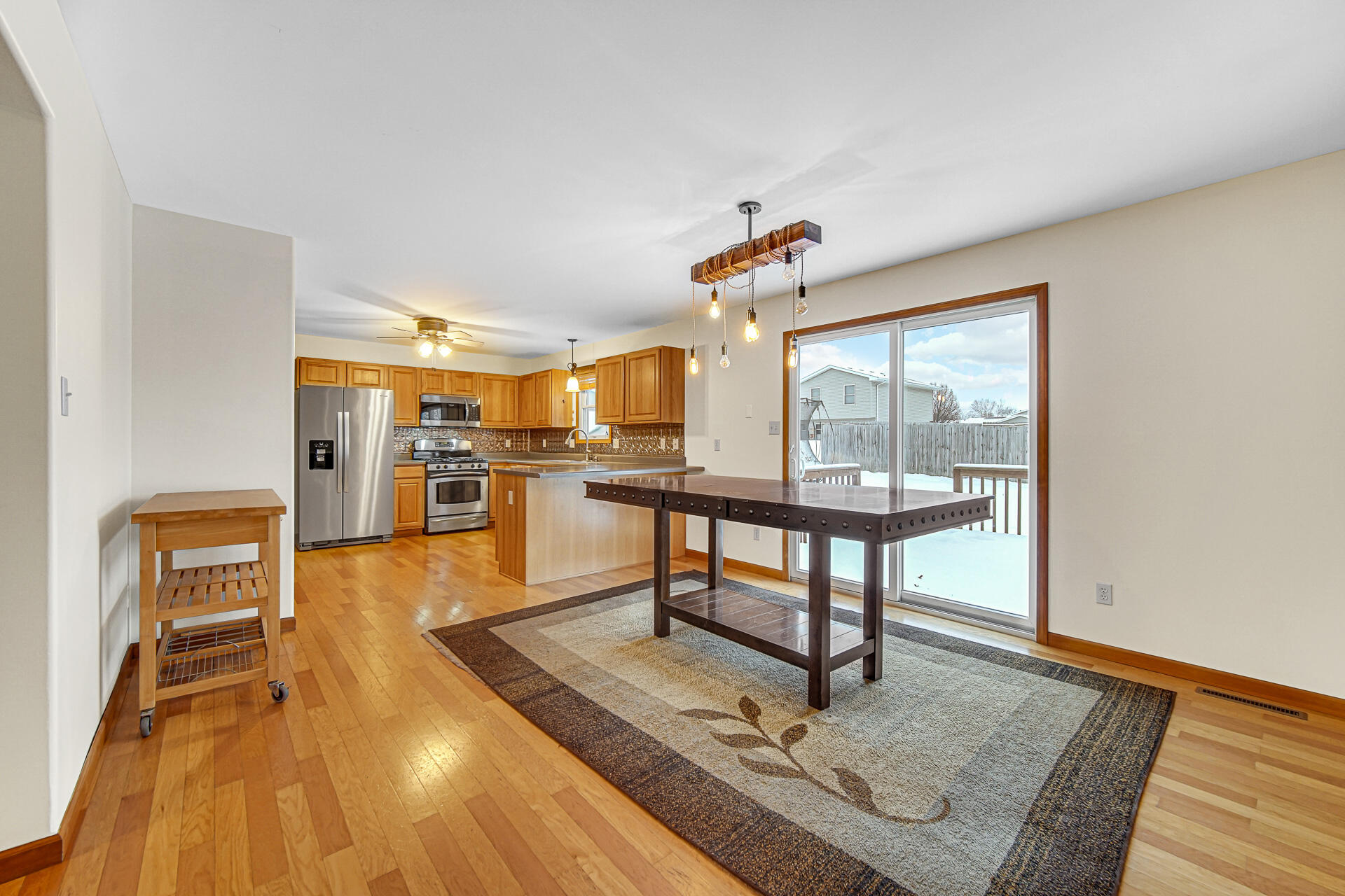 515 Tamarack Trail Hebron, IN 46341 - Photo 9 of 38 a living room with furniture a large window and wooden floor