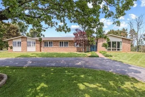a view of house with a yard