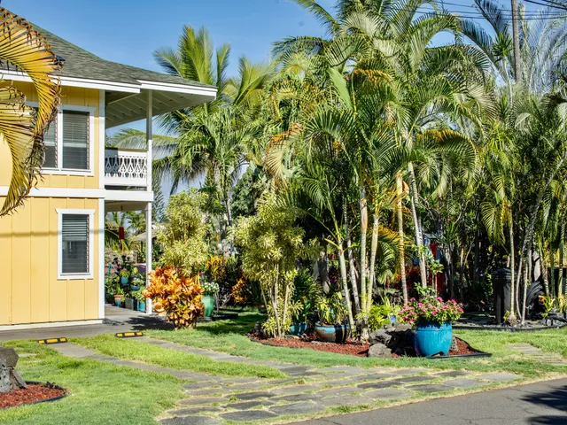 a front view of a house with a garden