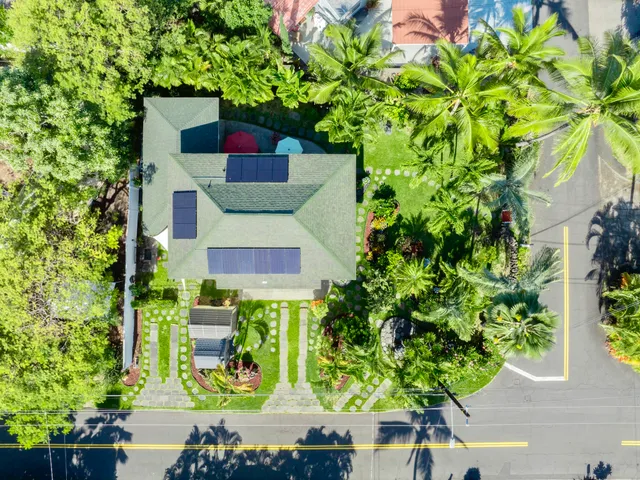 an aerial view of a house with a yard