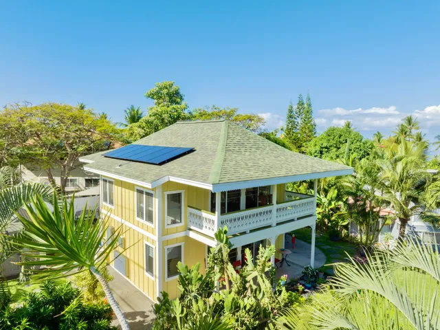 a aerial view of a house with a yard