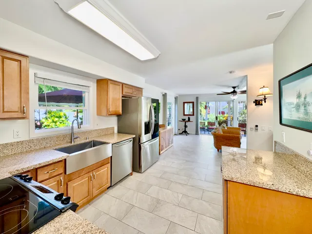a large kitchen with kitchen island granite countertop a large counter top and living room