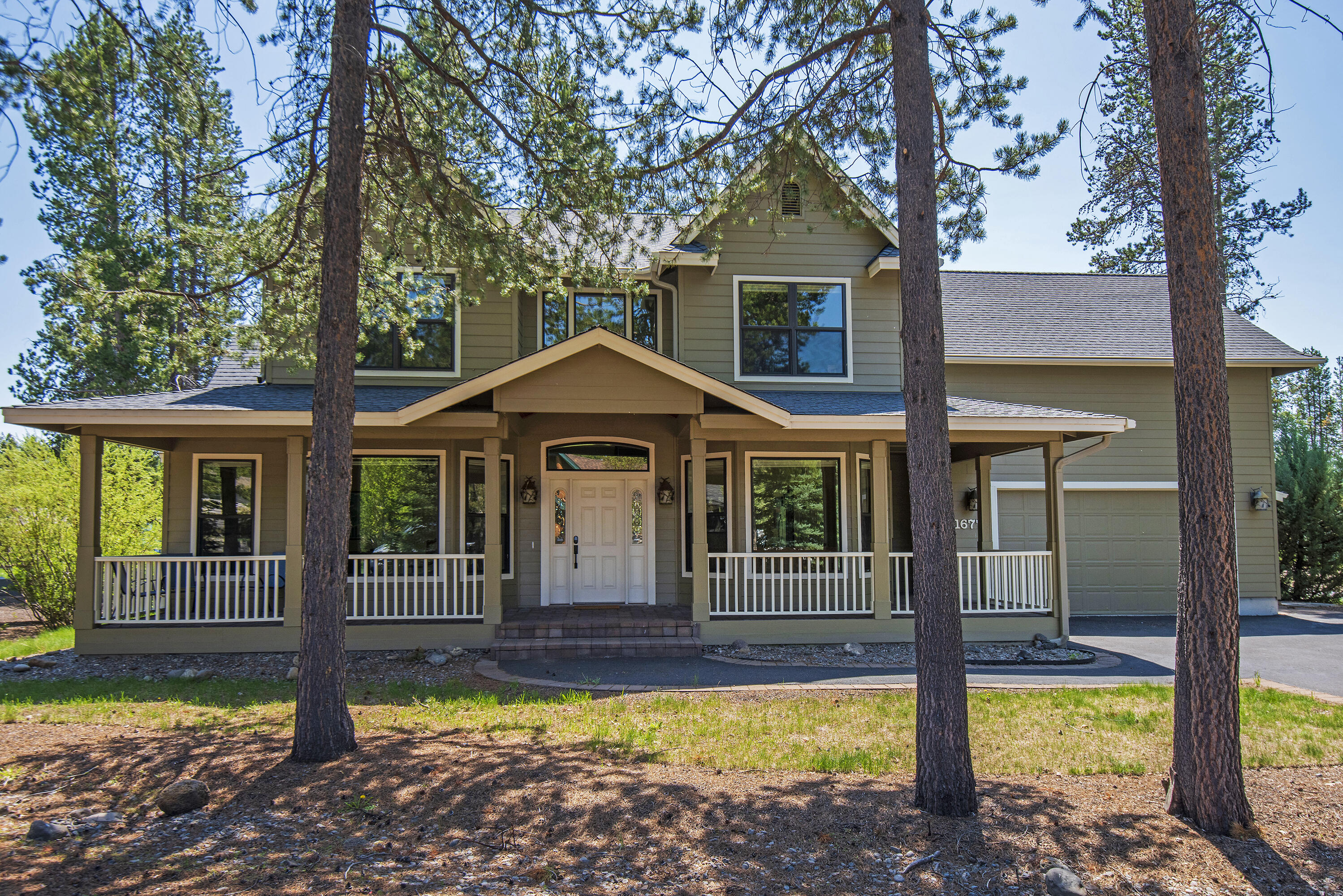 16775 Pony Express Way Bend, OR 97707 - Photo 3 of 38 a front view of a house with swimming pool and porch