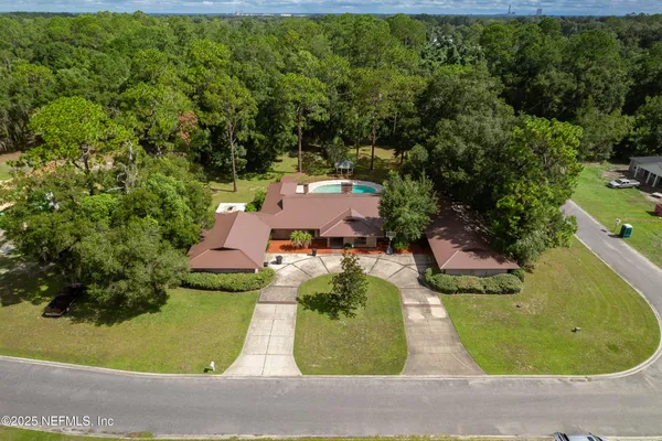 an aerial view of a house with a swimming pool